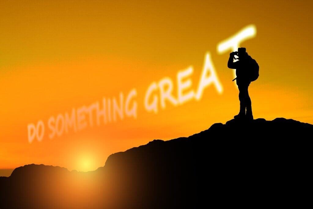 Silhouette of a hiker at sunset with "Do Something Great" in the sky, promoting solar energy.