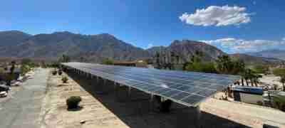 Large solar panel installation on a sunny day overlooking mountains, representing commercial solar services by LA Solar Group.